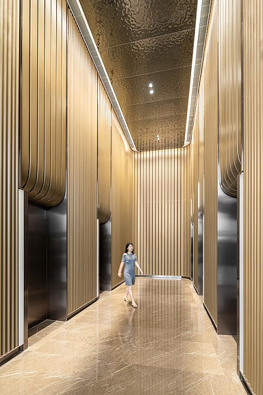 A girl walking down a hall.